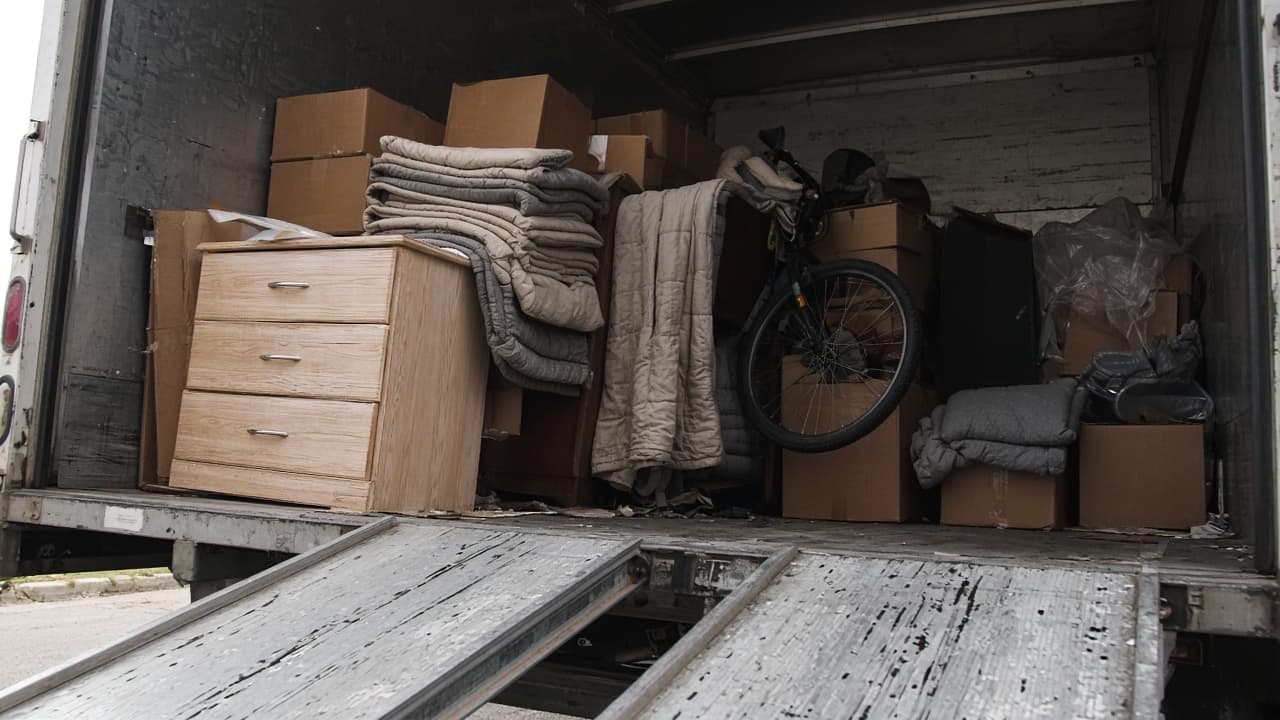 Ramp into a 26-foot US box truck loaded with a dresser, bike, pads, and cartons